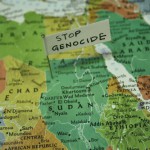 Close up of map of africa with a note pined saying "Stop Genocide"